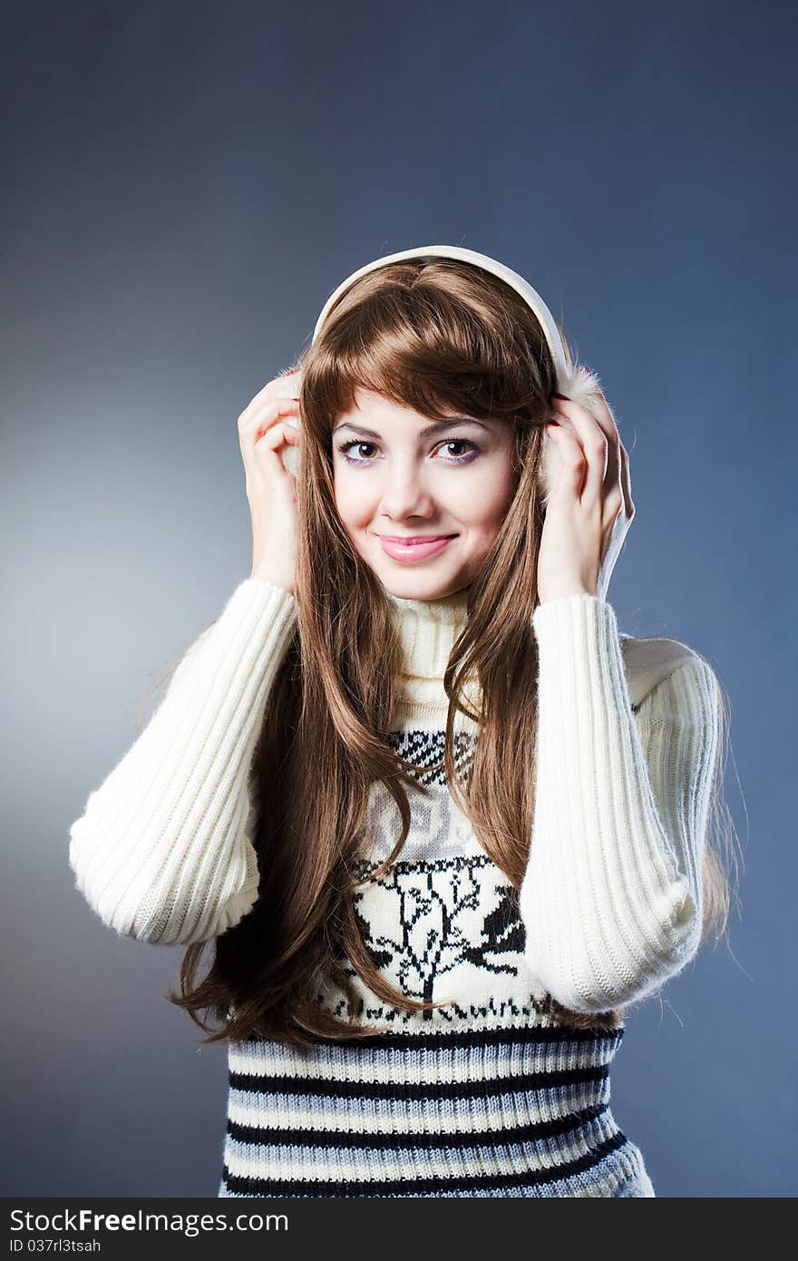 Young beautiful girl rejoices to snow, On a dark blue background