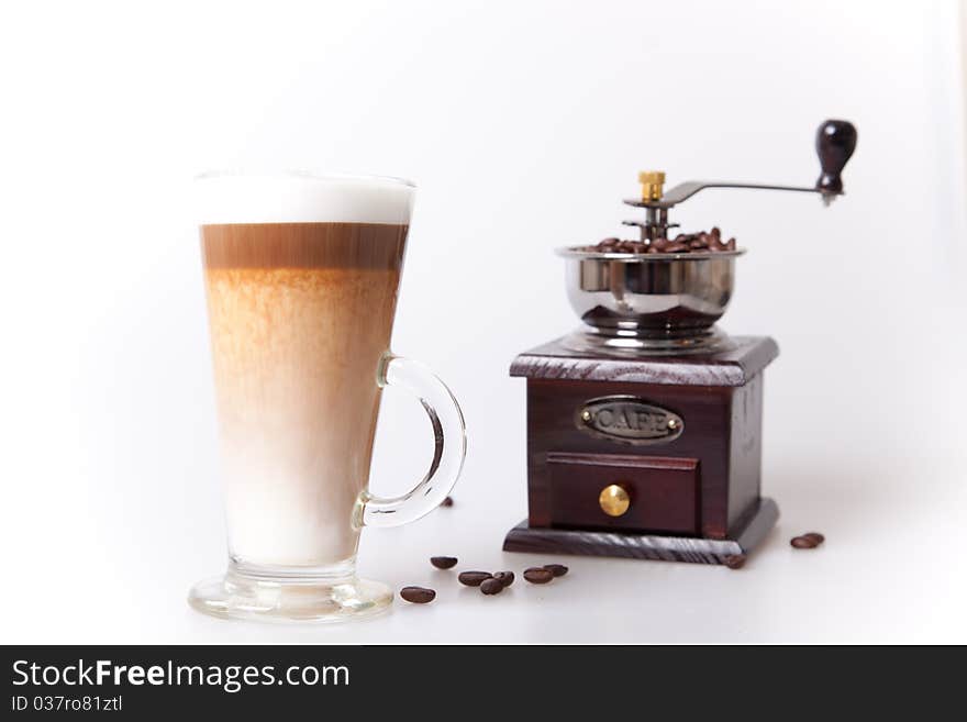 Coffee cup with coffee maker and beans in white background