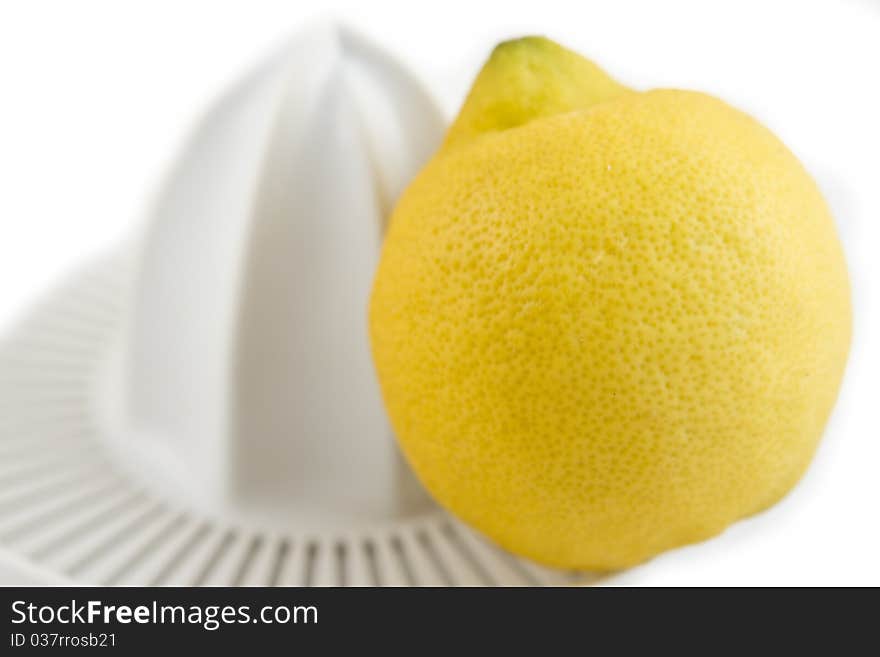 Lemon and juicer isolated on white background