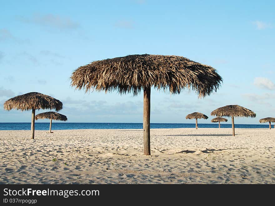 Beautiful white Cuban beach with parasols and turquoise sea. Beautiful white Cuban beach with parasols and turquoise sea