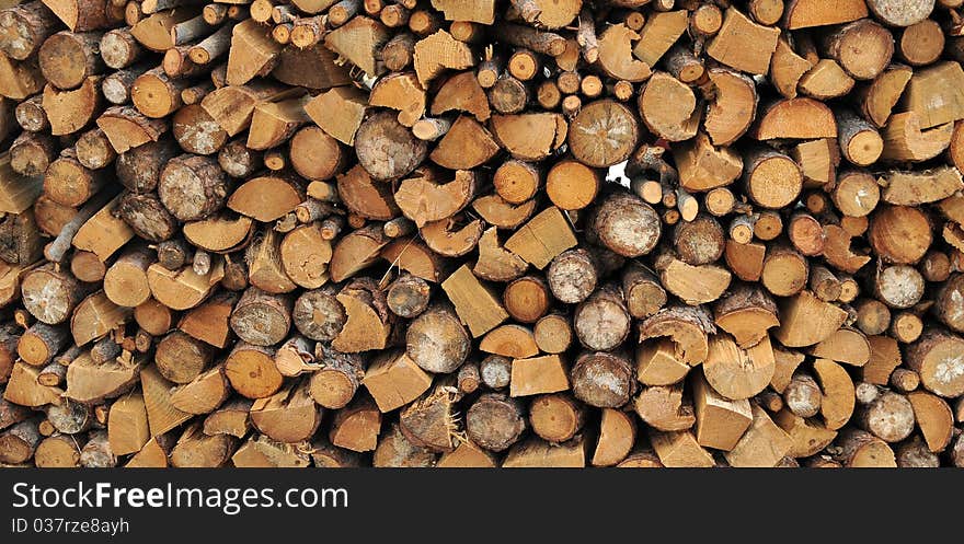 Logs of firewood in a nice stack, all piled up together.