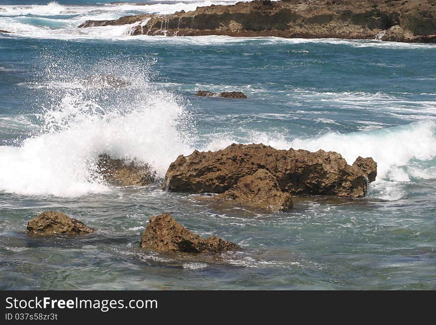 Rocky shoreline on Maui where surfers and turtles coexist. Rocky shoreline on Maui where surfers and turtles coexist