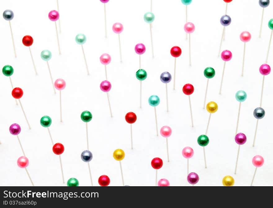 Colorful pins on a white background