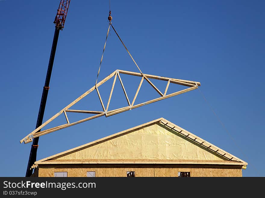 Crane lifting a roof onto a townhome. Crane lifting a roof onto a townhome