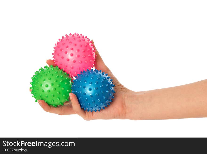 Mother stretches three colored massage balls for the children's hands development to her baby