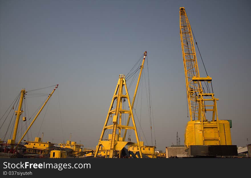 Cargo ships with their own cranes are docked at the shipyards in Hong Kong. Cargo ships with their own cranes are docked at the shipyards in Hong Kong.