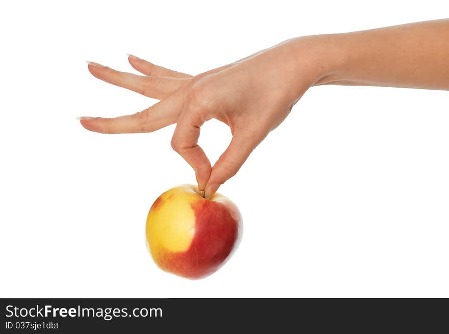 Woman holding in the hand one fresh yellow with red-edged apple