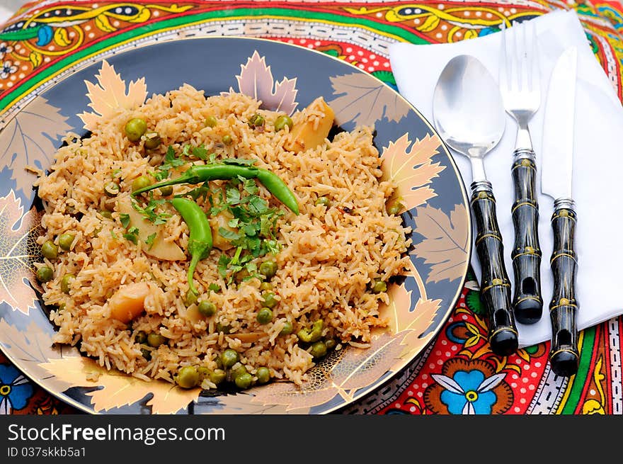 South Asian Traditional brown rice cooked with Potato, green peas, green chilies and tomatoes. South Asian Traditional brown rice cooked with Potato, green peas, green chilies and tomatoes.