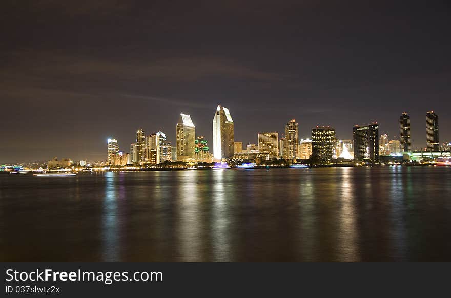 Downtown San Diego at night. Boats on the bay decorated with lights show motion blur. Downtown San Diego at night. Boats on the bay decorated with lights show motion blur.