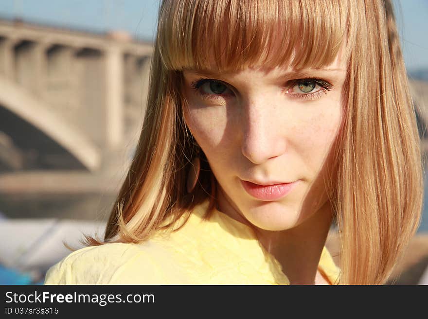 Blond girl in yellow blouse