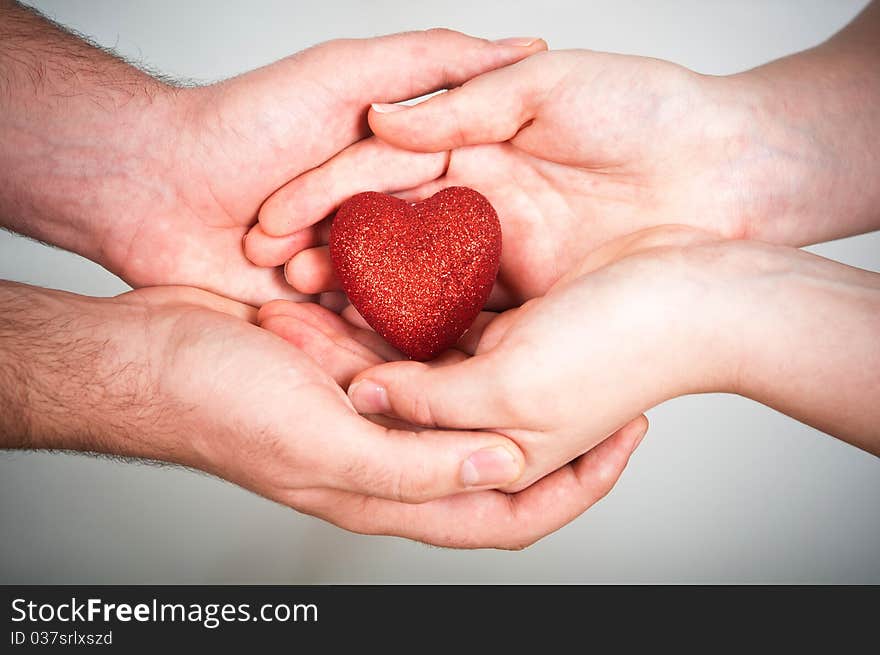 Man and woman hold red heart. Man and woman hold red heart