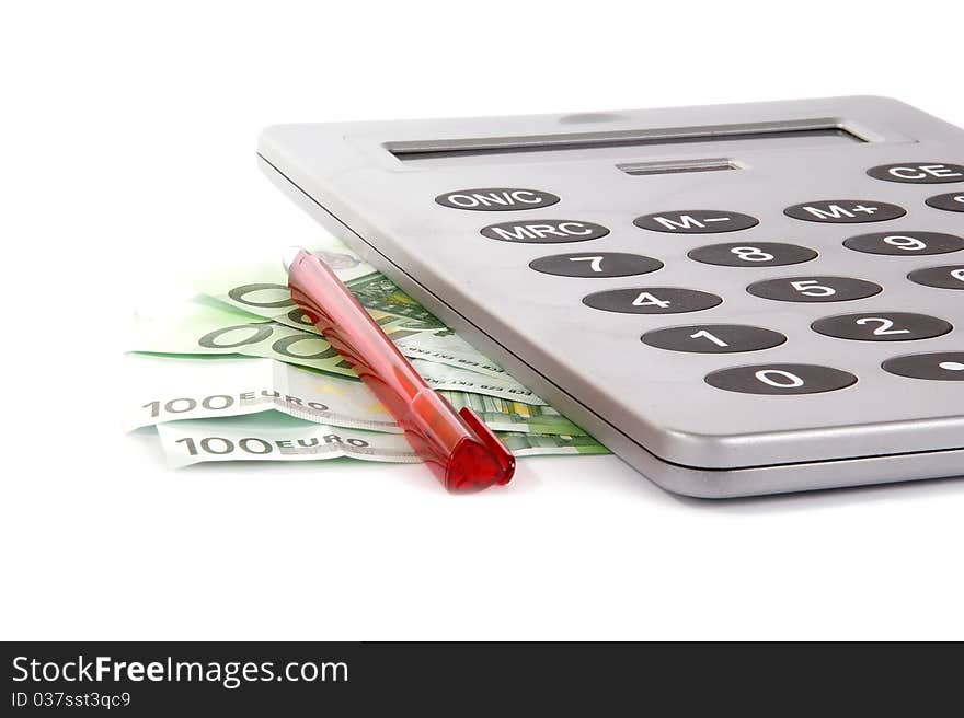 A large calculator with a red pen and the bills of a hundred euros on a white background