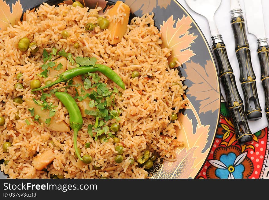 South Asian Traditional brown rice cooked with Potato, green peas, green chilies and tomatoes. South Asian Traditional brown rice cooked with Potato, green peas, green chilies and tomatoes.