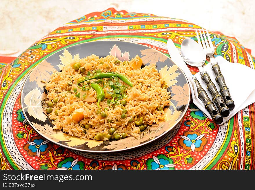 South Asian Traditional brown rice cooked with Potato, green peas, green chilies and tomatoes. South Asian Traditional brown rice cooked with Potato, green peas, green chilies and tomatoes.