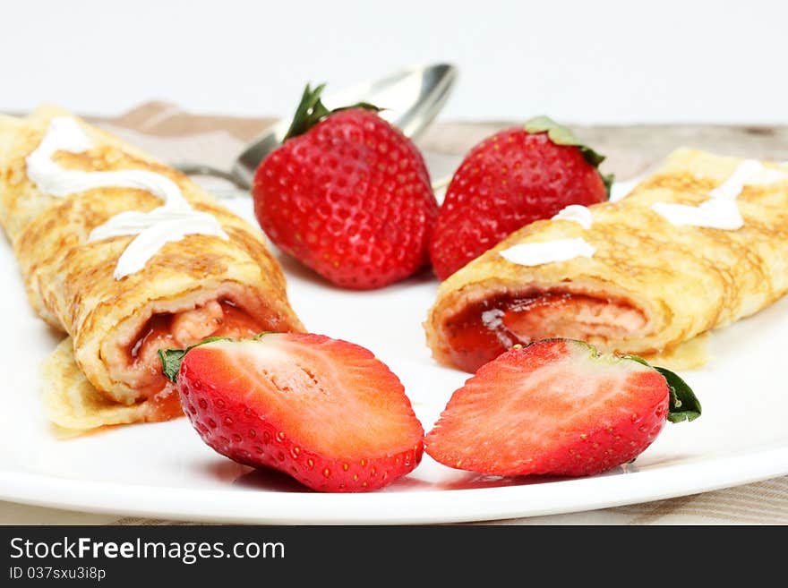 Pancakes with cream and strawberry