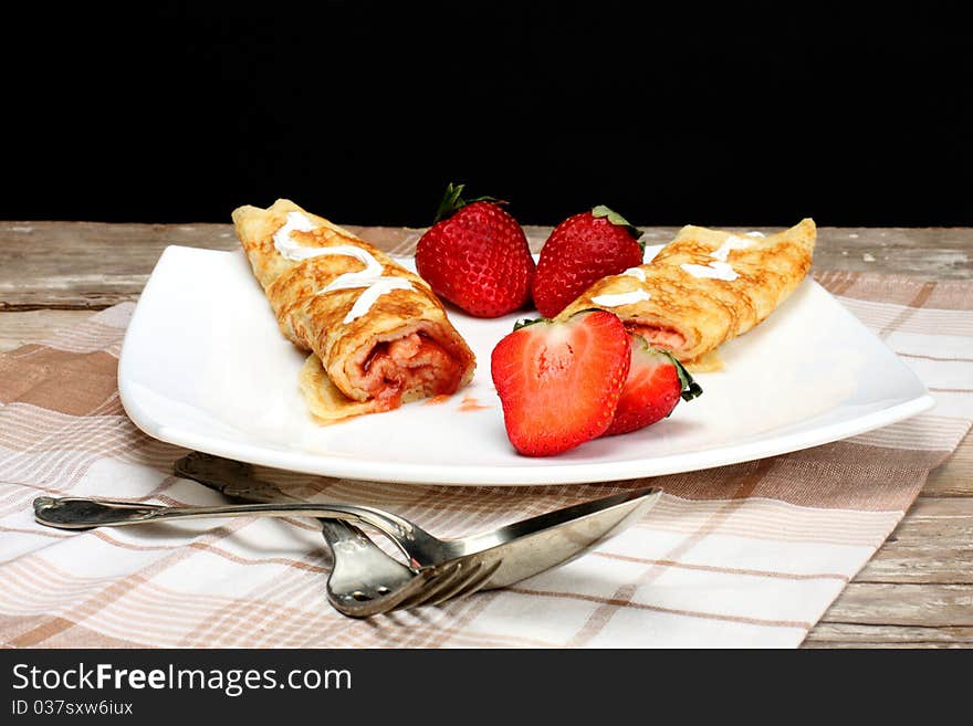 Pancakes with cream and strawberry