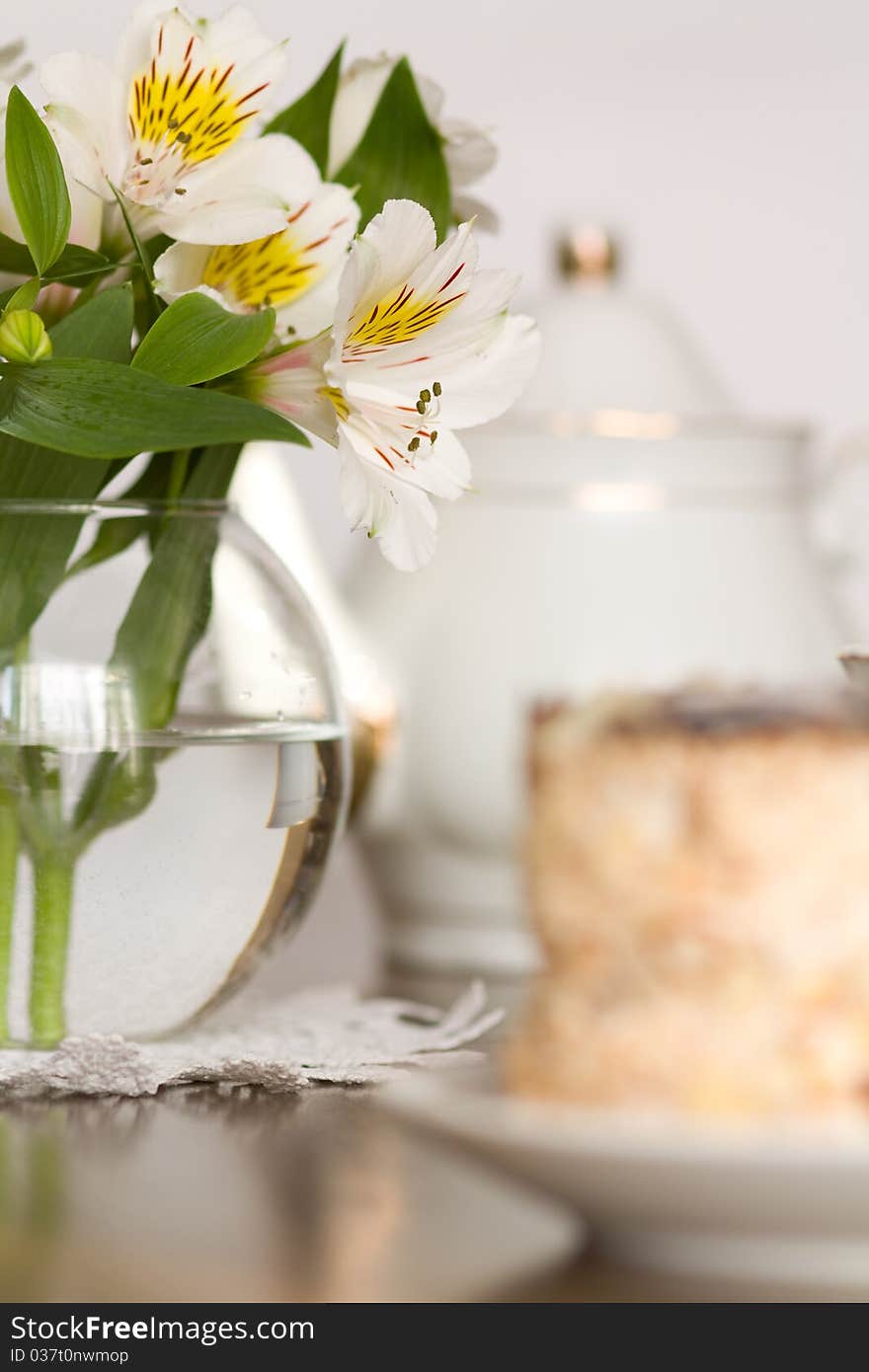 Delicate Flower In Glass Vase On Wooden Table