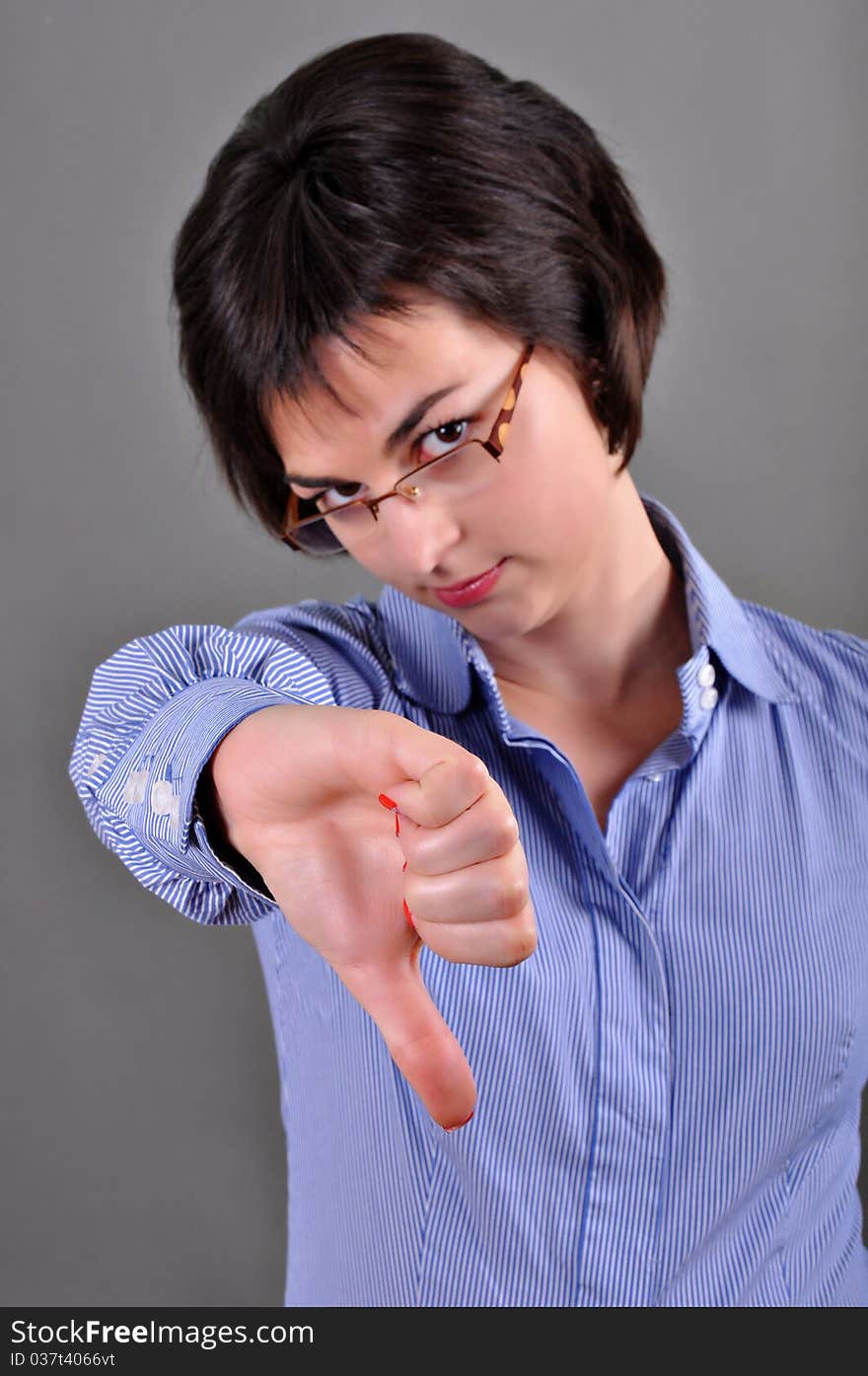 Business woman thumbs down isolated on white