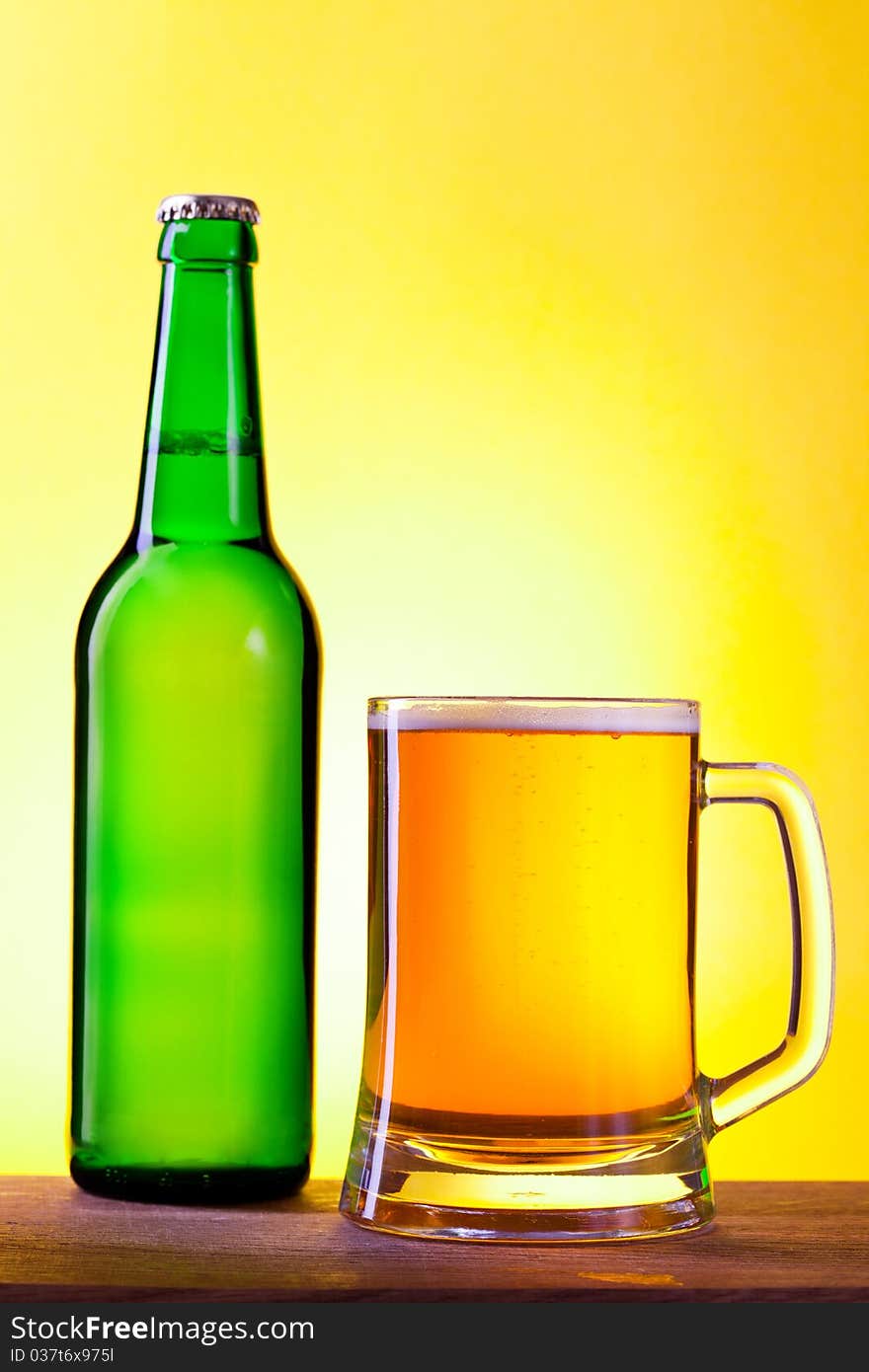 Green bottle of beer with a glass of beer. Green bottle of beer with a glass of beer