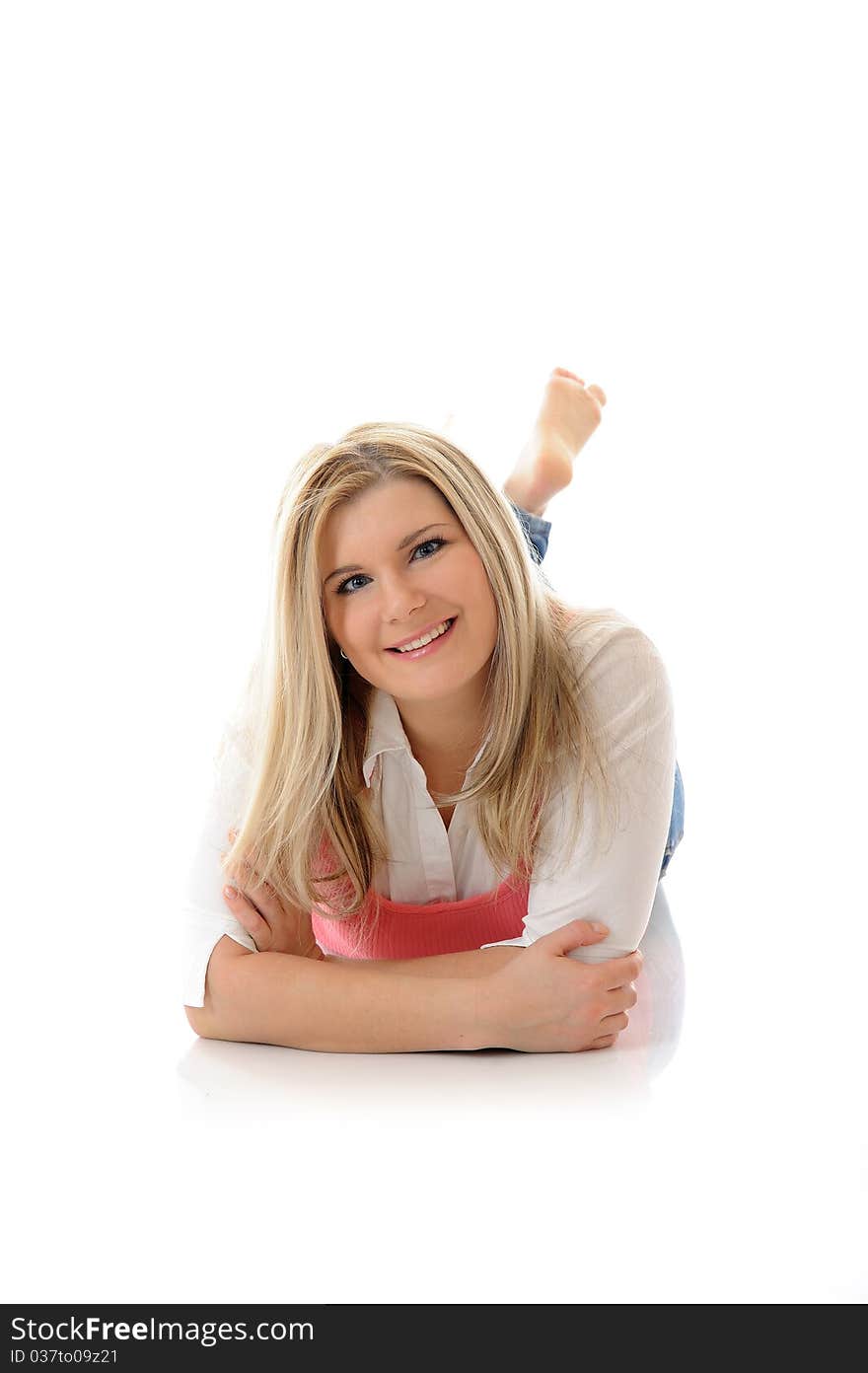 Young casual smiling woman lying on the floor isolated on white background