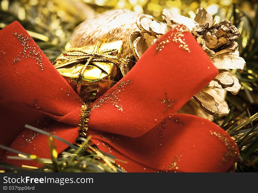 Close up of big red bow with golden christmas decoration. Close up of big red bow with golden christmas decoration.