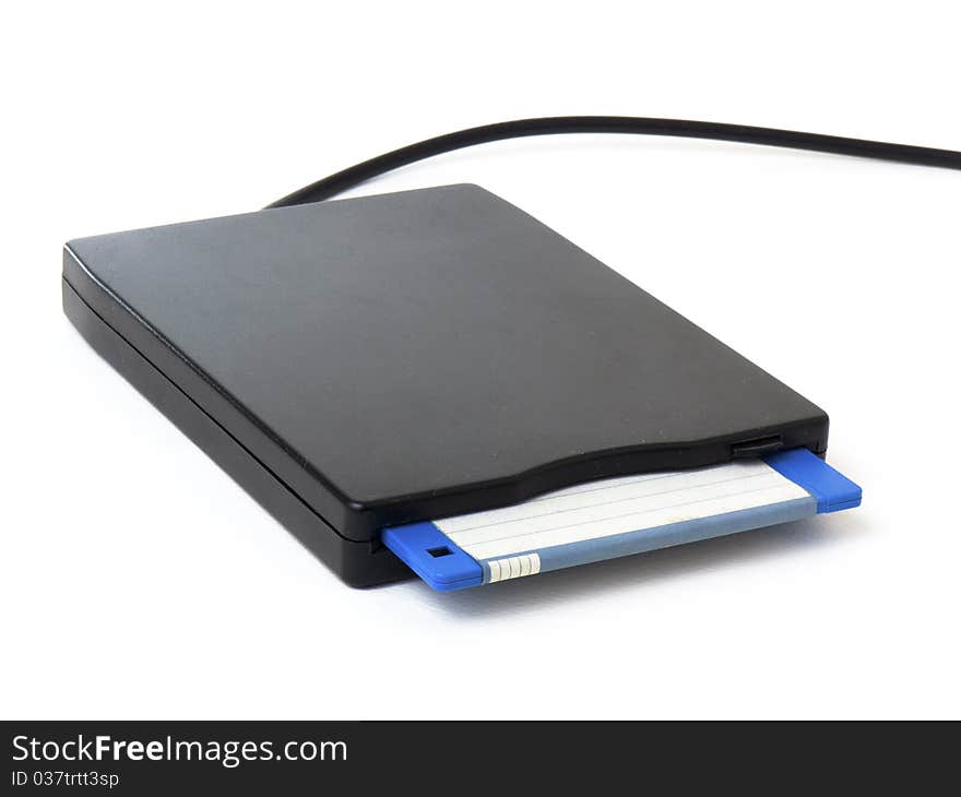 A black external usb floppy disk drive with a blue disk inside, isolated on white background. A black external usb floppy disk drive with a blue disk inside, isolated on white background