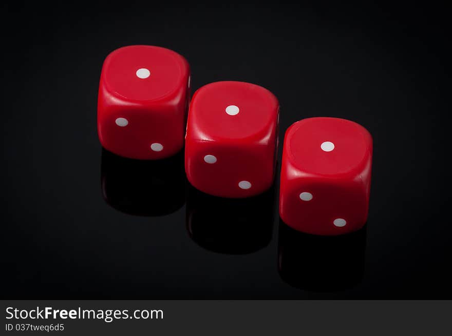 Closeup of three red dice on green background. Closeup of three red dice on green background