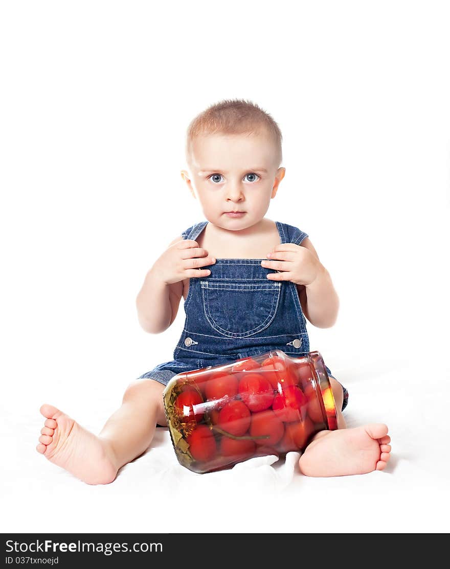 Small beautiful baby boy with tin of tomatoes on a white background