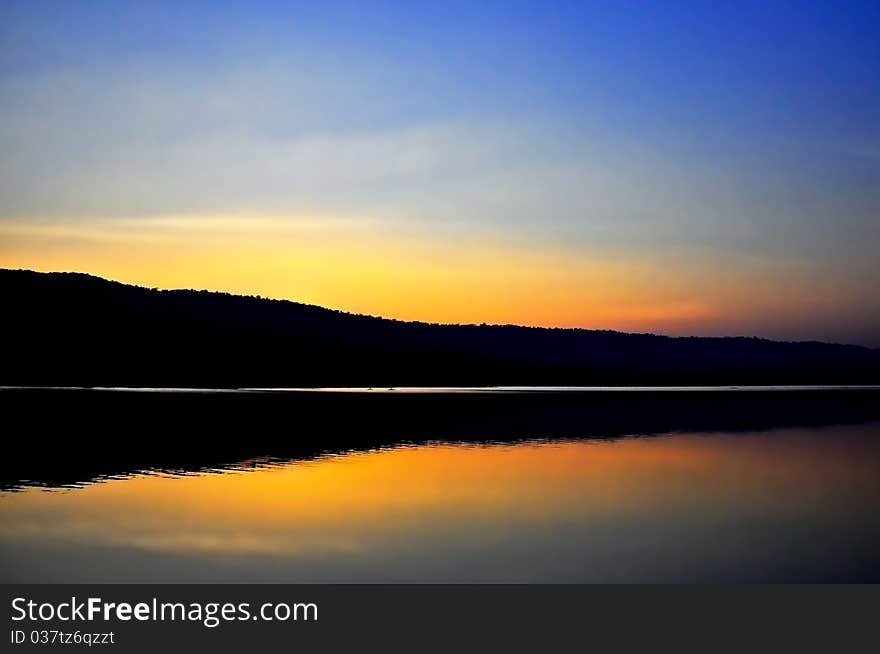 Beautiful sunset along the dam reflect on water surface