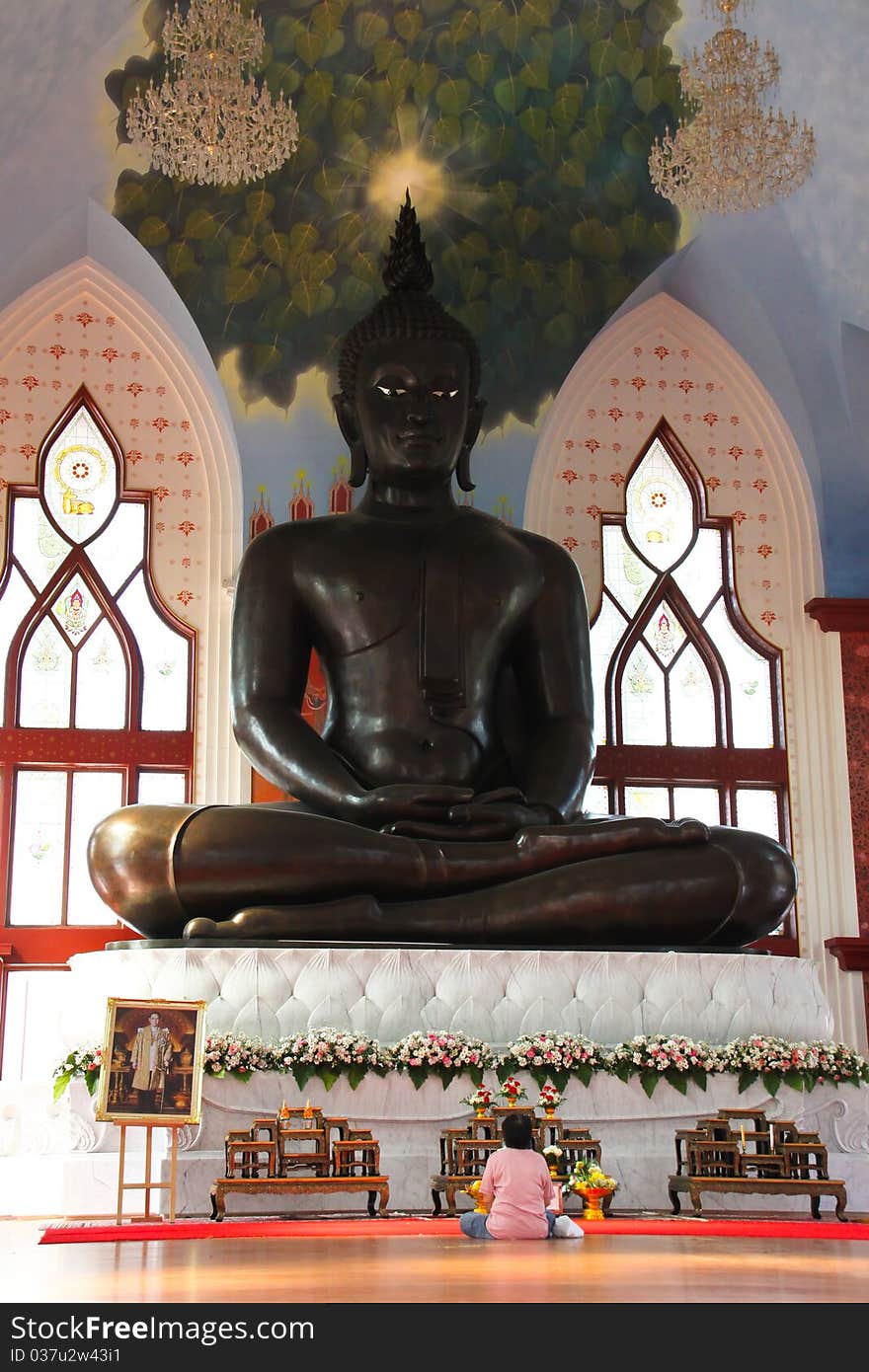 A woman worships image of Buddha. A woman worships image of Buddha.