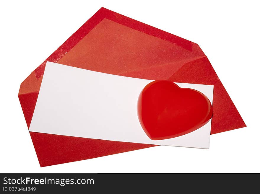 Red heart laying next to a red envelope with white paper on a white background. Red heart laying next to a red envelope with white paper on a white background.