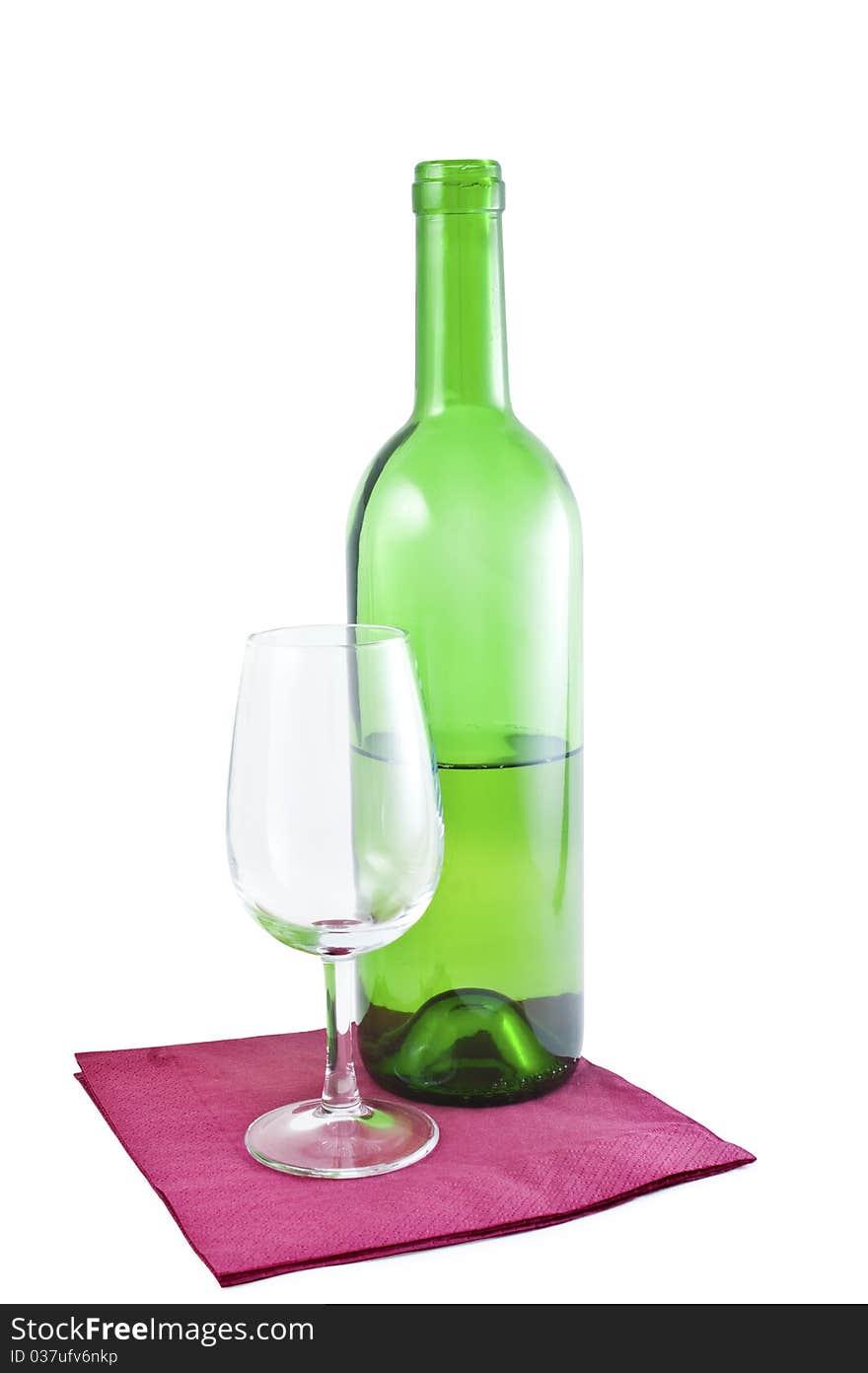 Bottle of white wine and an empty glass on the serviette isolated on white. Bottle of white wine and an empty glass on the serviette isolated on white