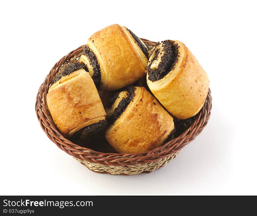 Sweet delicious poppy rolls in the wicker plate isolated on white. Sweet delicious poppy rolls in the wicker plate isolated on white