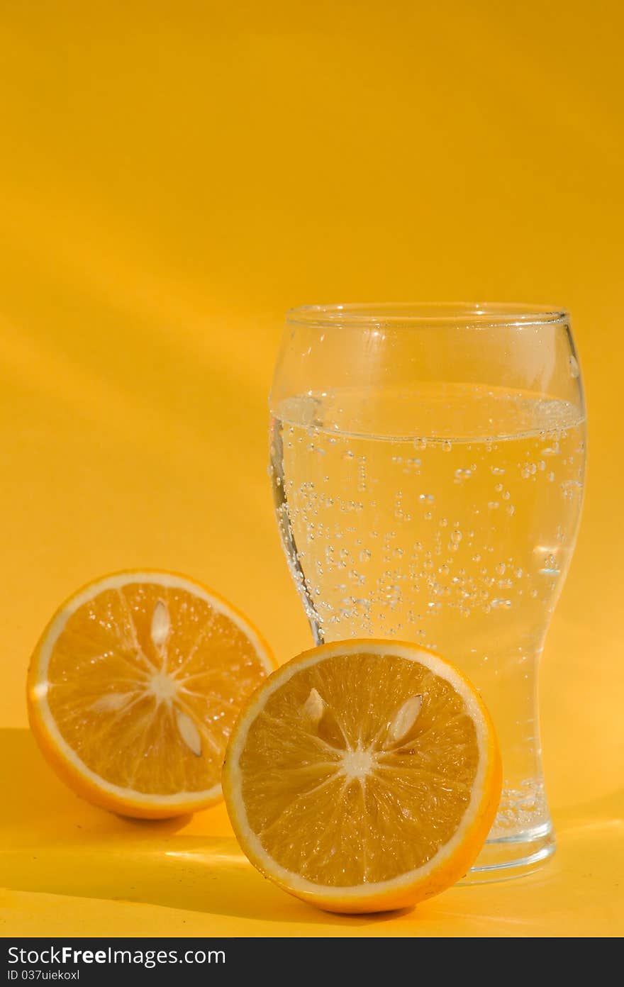 A Glass Of Soda And Two Chopped Oranges