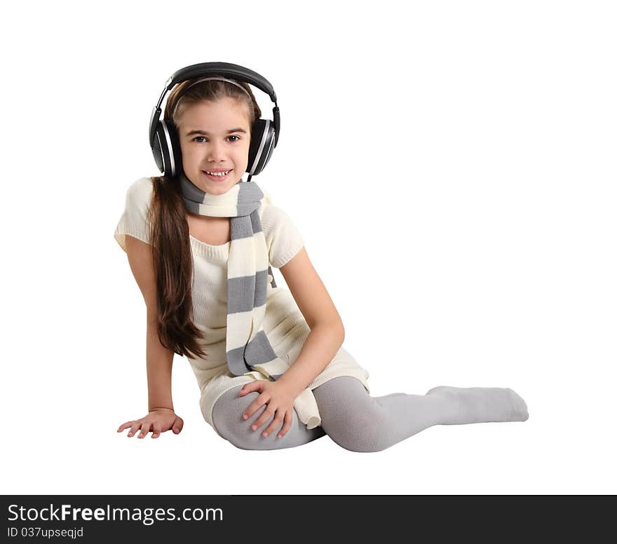 Cute little girl listening to the music. Studio