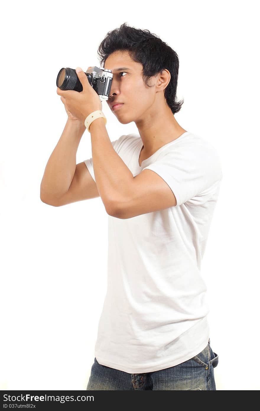 Young man taking a photograph with an old camera. Young man taking a photograph with an old camera