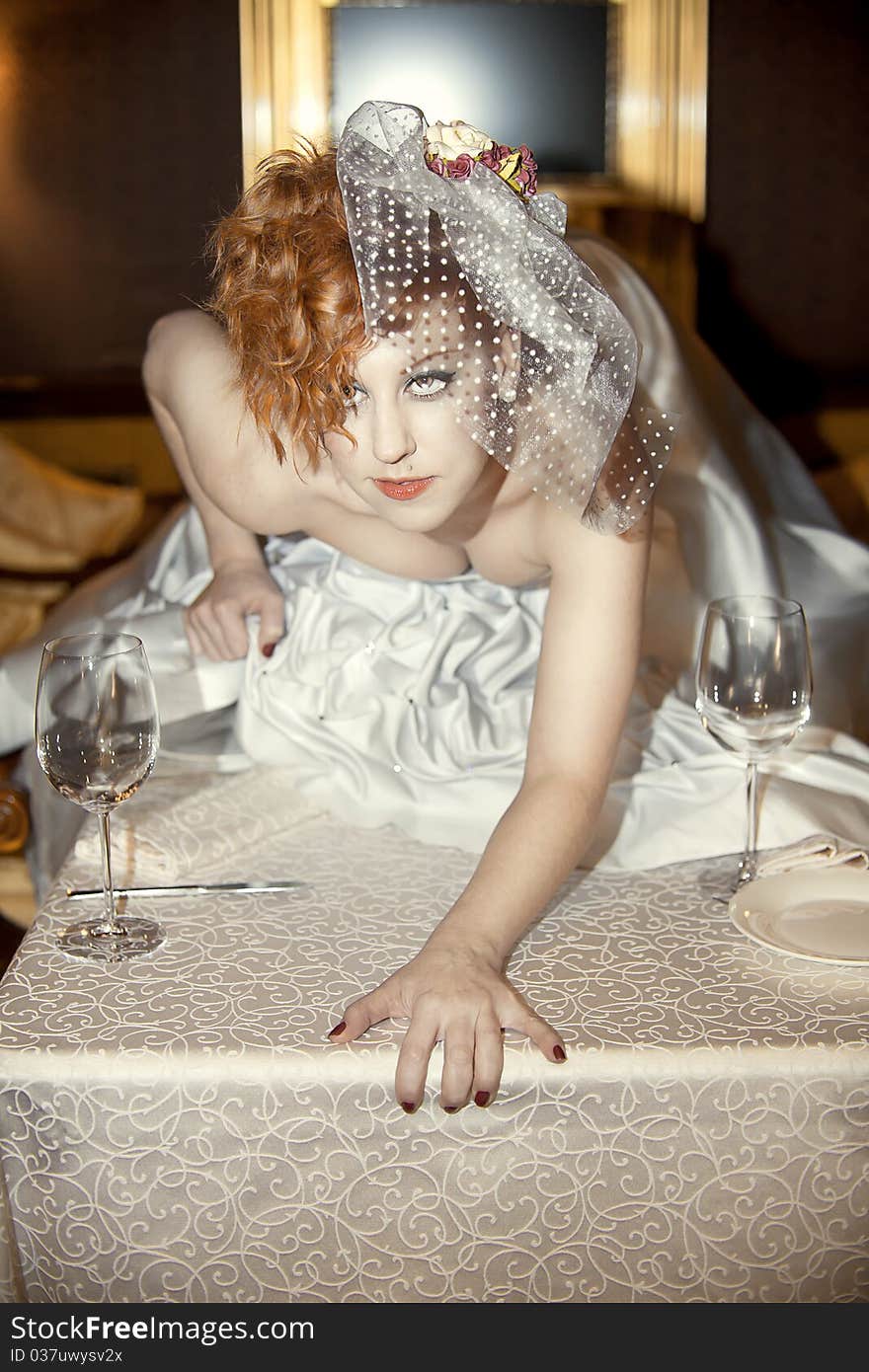 Bright girl with red hairs and bridal veil