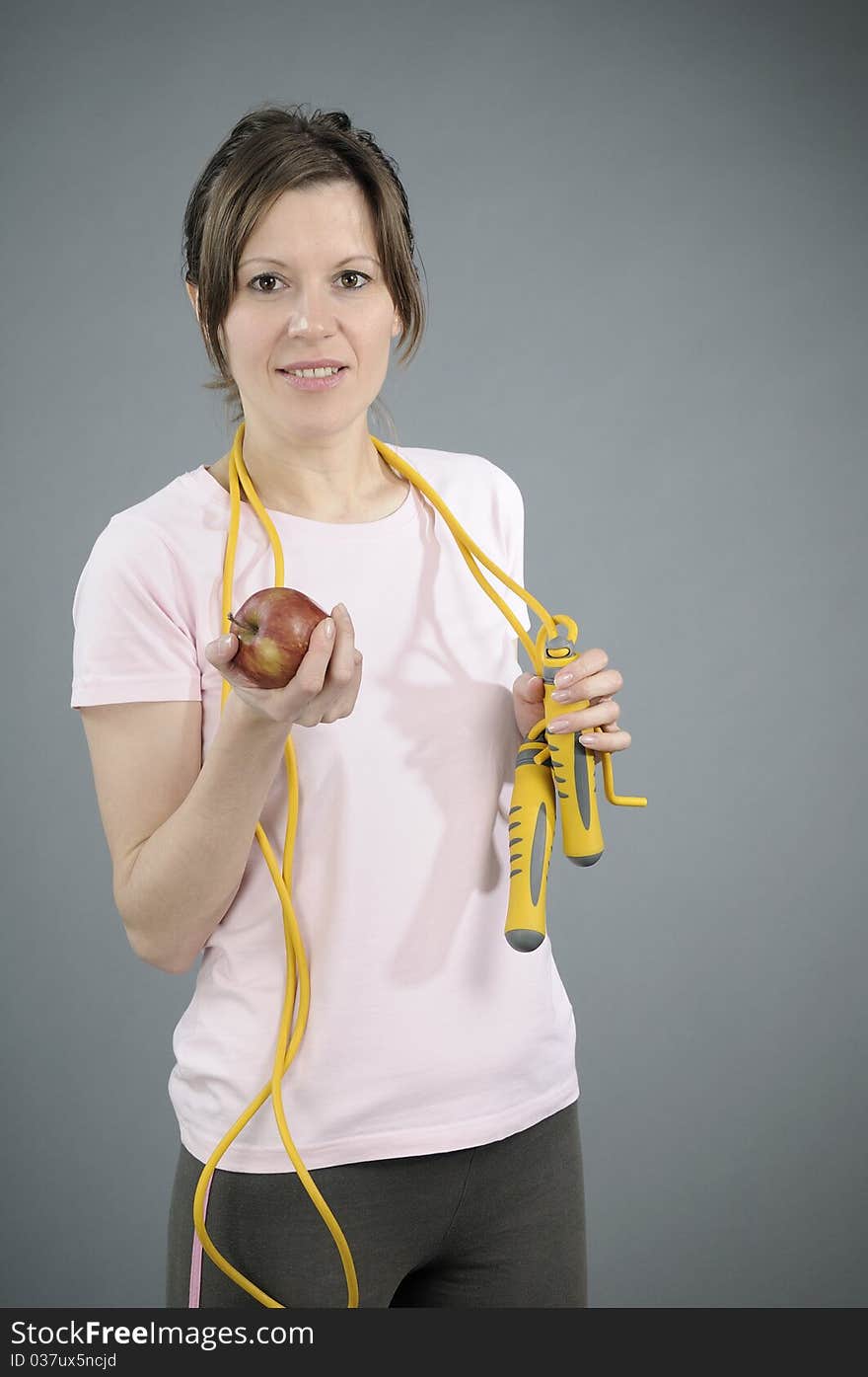 White woman relaxing with red fruit and preparing to eat it. White woman relaxing with red fruit and preparing to eat it