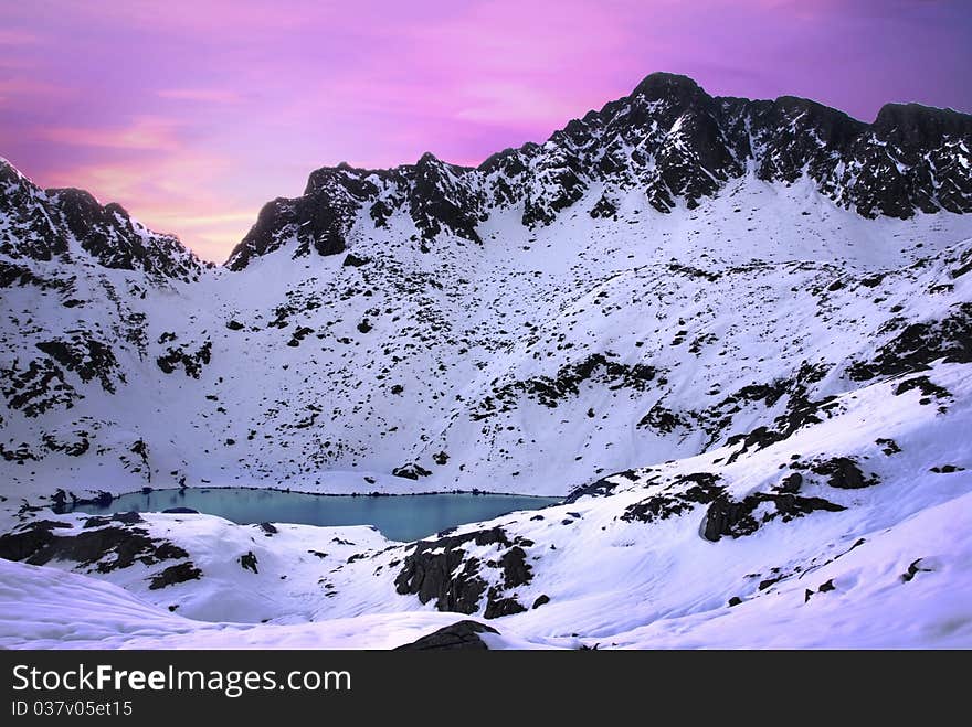 Glacier lake and the Alps mountains covered by snow at sunrise. Glacier lake and the Alps mountains covered by snow at sunrise.