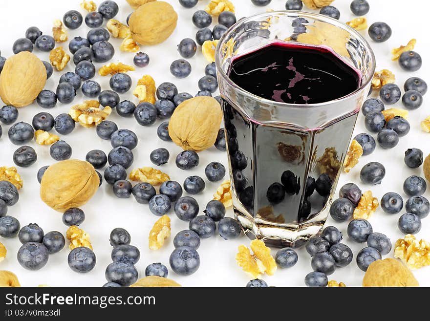 Juice of the dark blue purple berry enjoys the beautiful company of fresh organic whole berries and walnut pieces. Juice of the dark blue purple berry enjoys the beautiful company of fresh organic whole berries and walnut pieces.