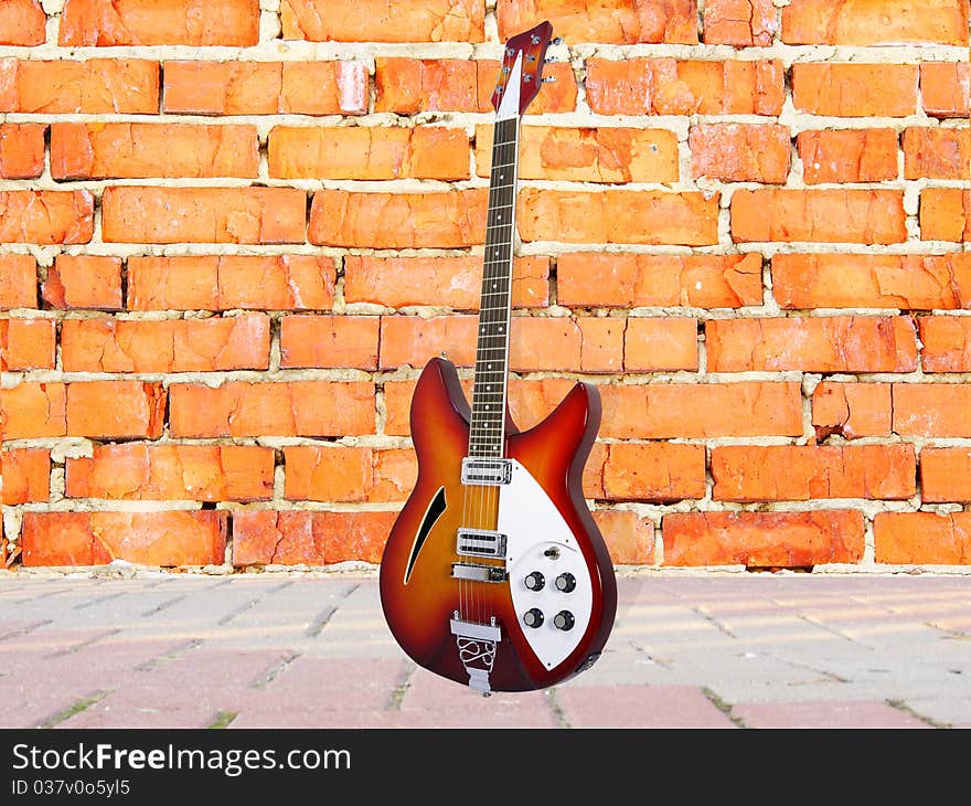 Background with the image of ruined brick wall and guitar