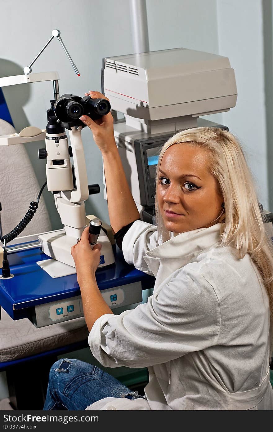 Young woman examining the eyesight in the optician's