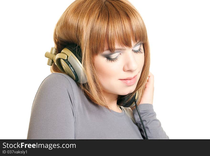 Beautiful red-haired girl with headphones isolated over a white background. Beautiful red-haired girl with headphones isolated over a white background