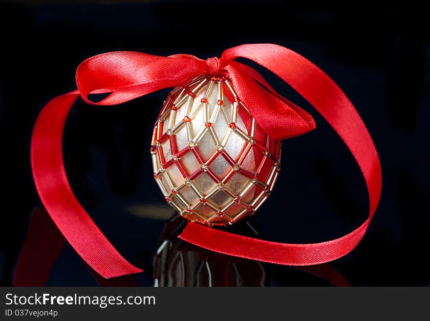 Eggs decorated with beads over the black background. Eggs decorated with beads over the black background