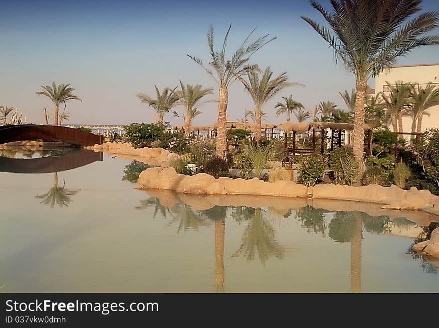 Egypt resort beach with artificial river, sepia.