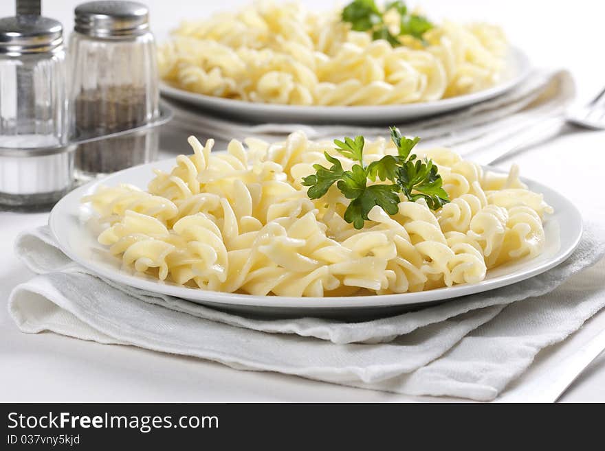 Two plates of pasta with parsley