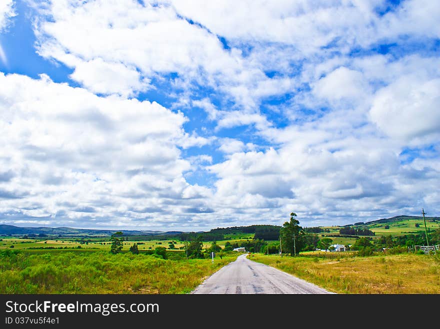 Route under a blue sky with white clouds. Route under a blue sky with white clouds