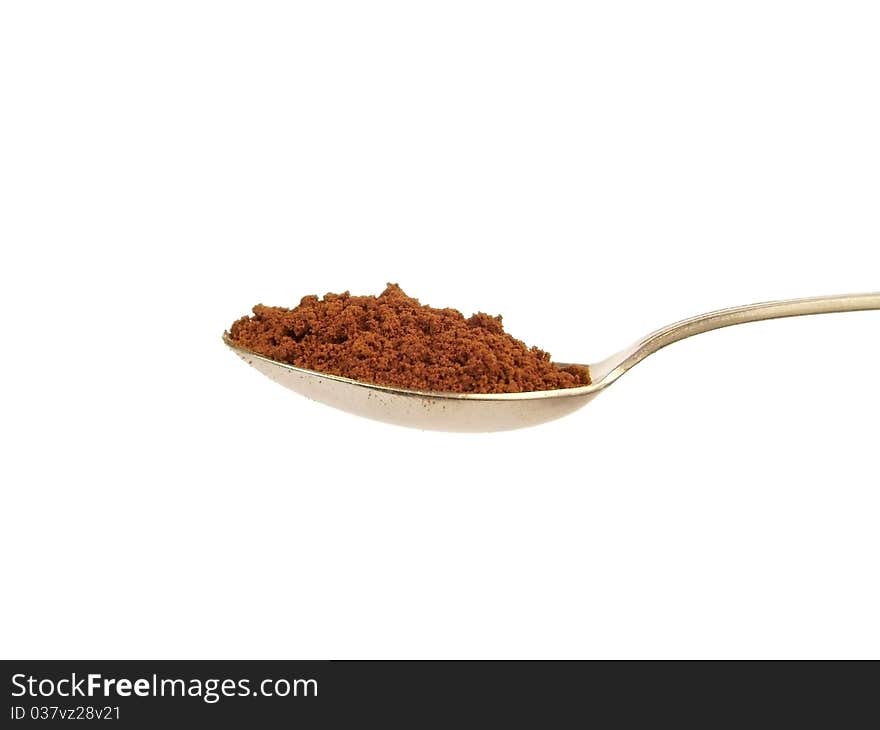 Spoon with coffee, isolated macro