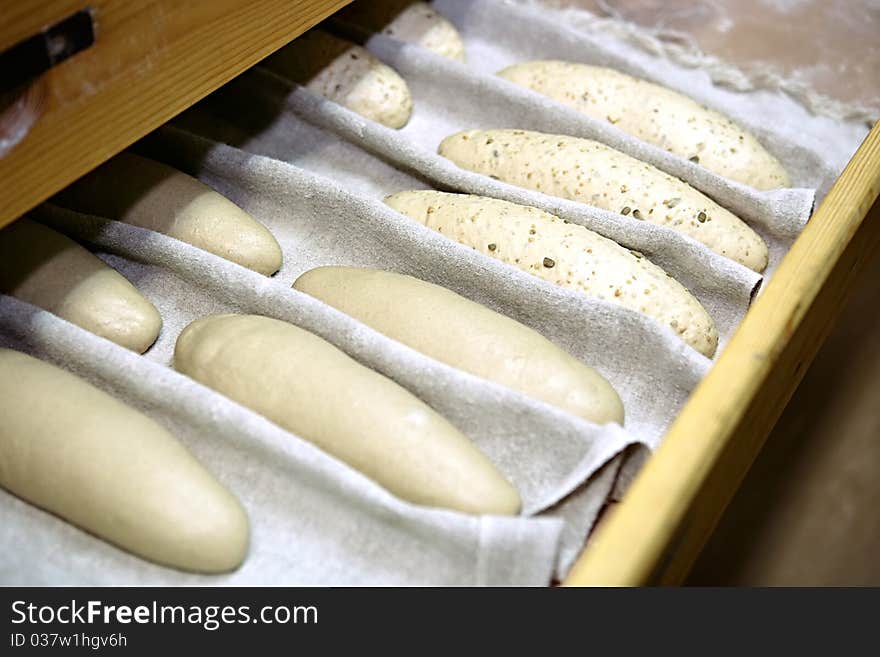 A few crude baguette on the bakery shelf. A few crude baguette on the bakery shelf