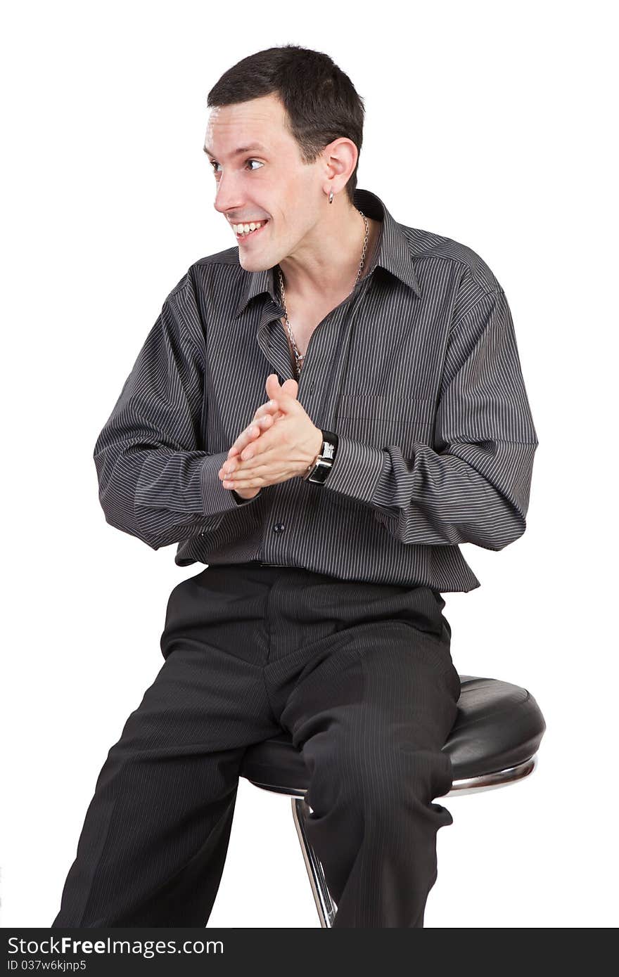 The young guy sits on a chair and rubs palms isolated on a white background. The young guy sits on a chair and rubs palms isolated on a white background